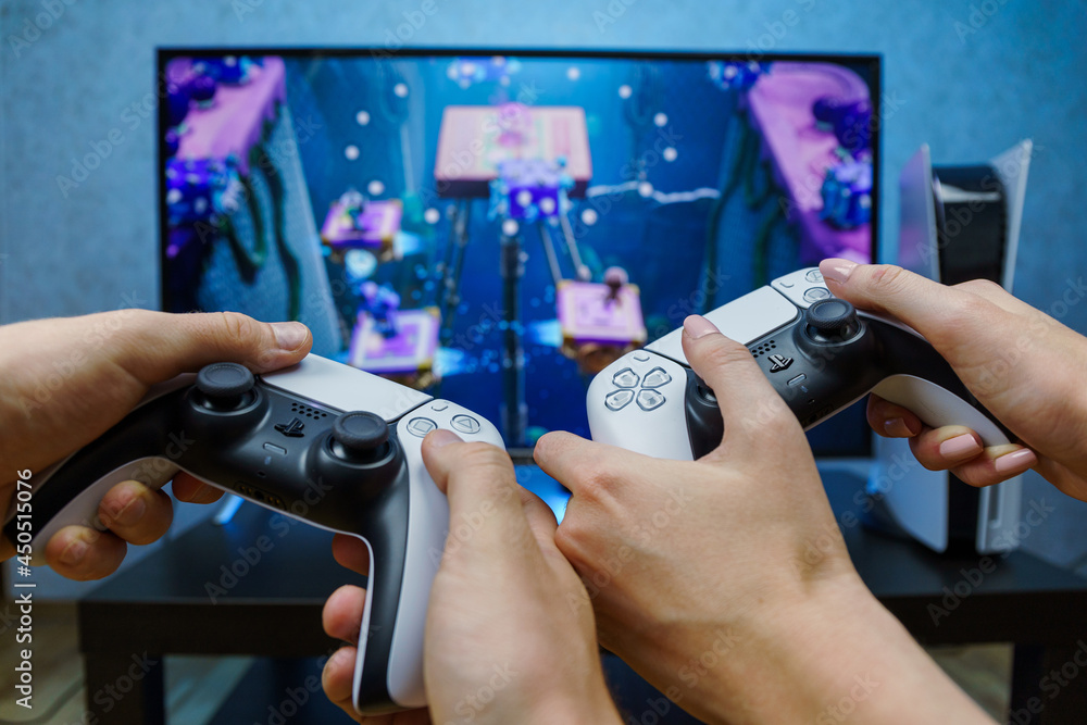 Sony PlayStation 5. New generation gaming computer. People playing video  games. Couple play play with PS5. Point of view. foto de Stock | Adobe Stock