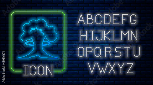 Glowing neon Nuclear explosion icon isolated on brick wall background. Atomic bomb. Symbol of nuclear war, end of world. Neon light alphabet. Vector