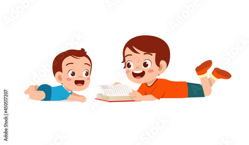 cute little boy read book with baby brother sibling together