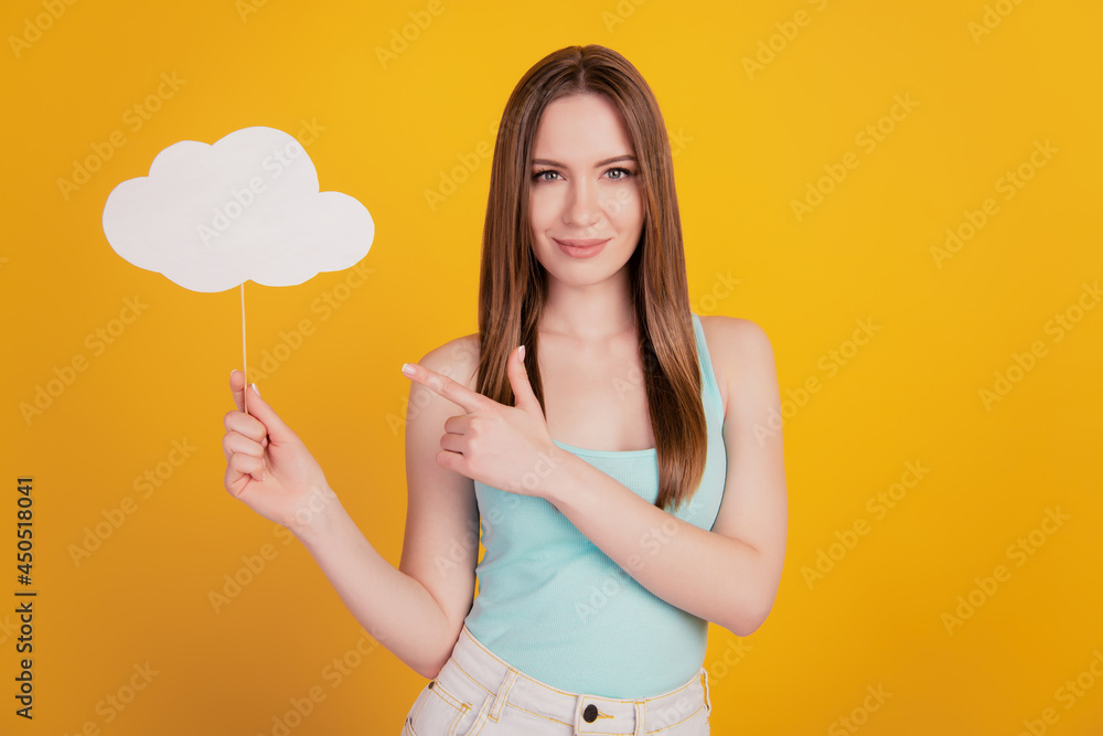 Portrait of pretty gorgeous lady hold cloud stick direct finger blank space advise forecast on yellow background Portrait of pretty gorgeous lady hold cloud stick direct finger blank space advise forecast on yellow background