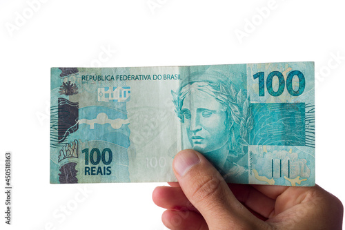 man holding hundred reais bills isolated on white. Brazilian money photo