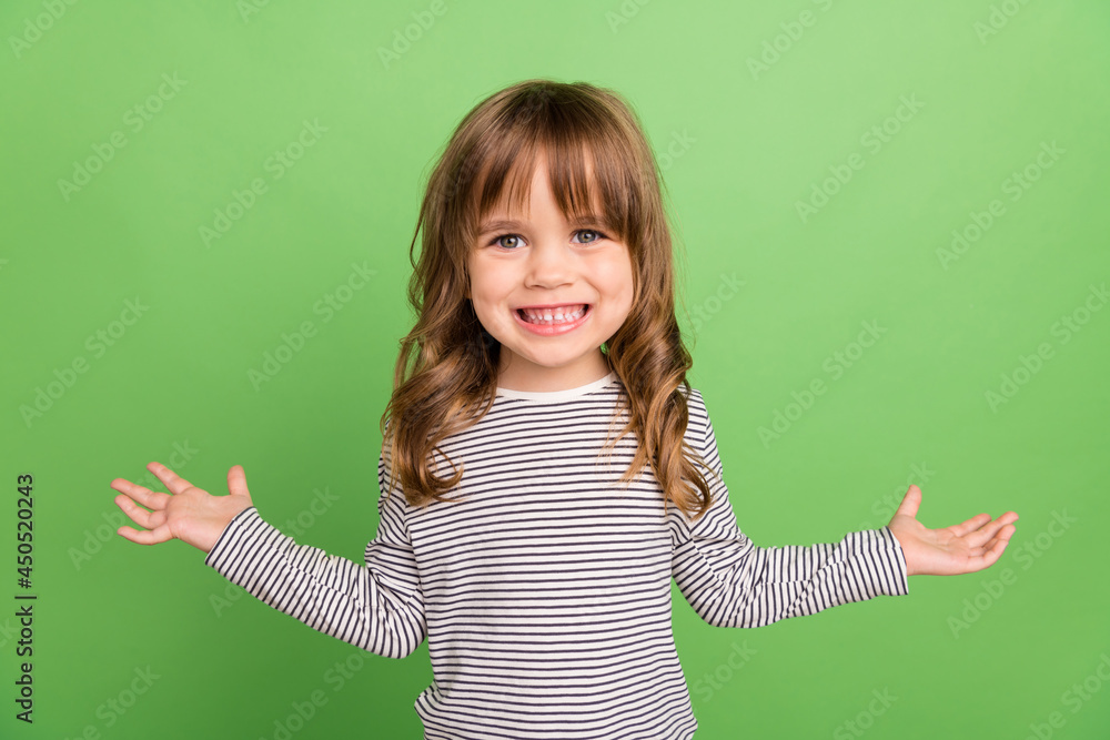 Photo of funny little blond hair girl hands hug wear striped shirt isolated on green color backgound Photo of funny little blond hair girl hands hug wear striped shirt isolated on green color backgound