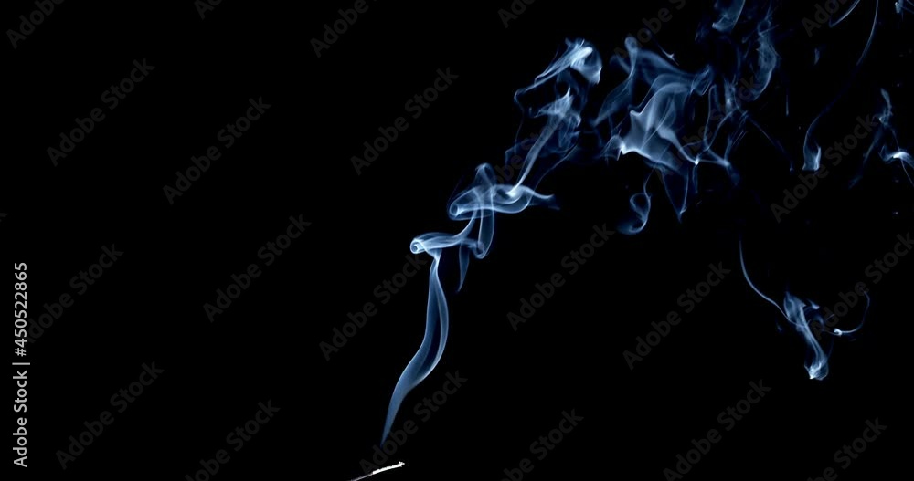 Incense stick are burning and smoke on black background, Smoke from incense. Slow motion. Real Smoke on black. Ideal for background or over-layer with blending mode add, screen, lighten. Incense stick are burning and smoke on black background, Smoke from incense. Slow motion. Real Smoke on black. Ideal for background or over-layer with blending mode add, screen, lighten.