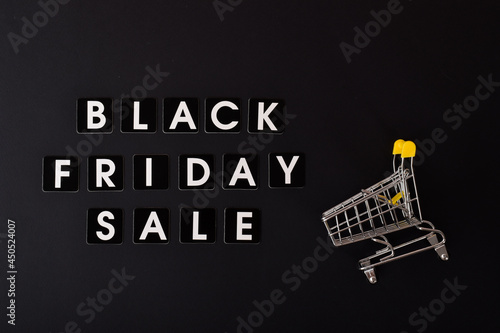 On a black background, the inscription Black Friday sale and a stroller from the supermarket.