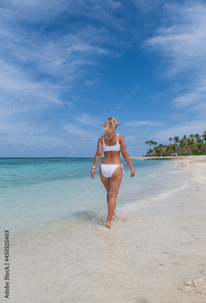 Fashion woman on the maldivian beach. Crossroads Maldives, saii lagoon. July 2021 Fashion woman on the maldivian beach. Crossroads Maldives, saii lagoon. July 2021