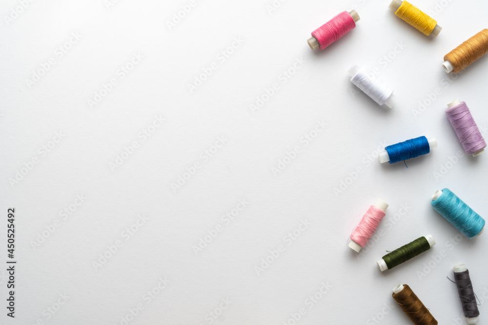 Flat lay composition with sewing thread on white background. Space for text Flat lay composition with sewing thread on white background. Space for text