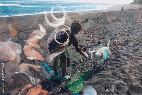 Asian woman cleans plastic from beach, volunteer concept.. photo