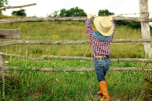 a little boy cowboy on nature