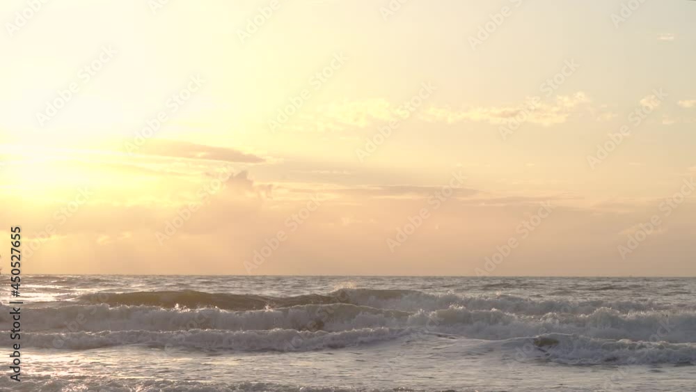 Beautiful sunset over the sea with waves crashing - Static slow motion Beautiful sunset over the sea with waves crashing - Static slow motion