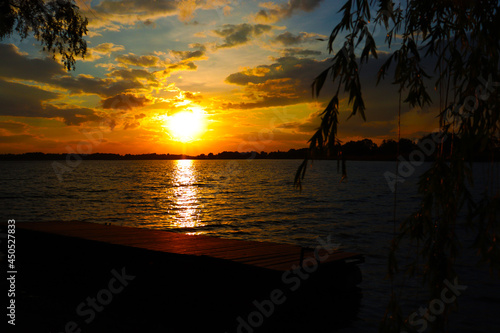 Fototapeta Naklejka Na Ścianę i Meble -  Colourful Sunset with Tree branch, Natural Dramatic sunrise seascape, Ocean or Sea view, Nature Background, Copyspace
