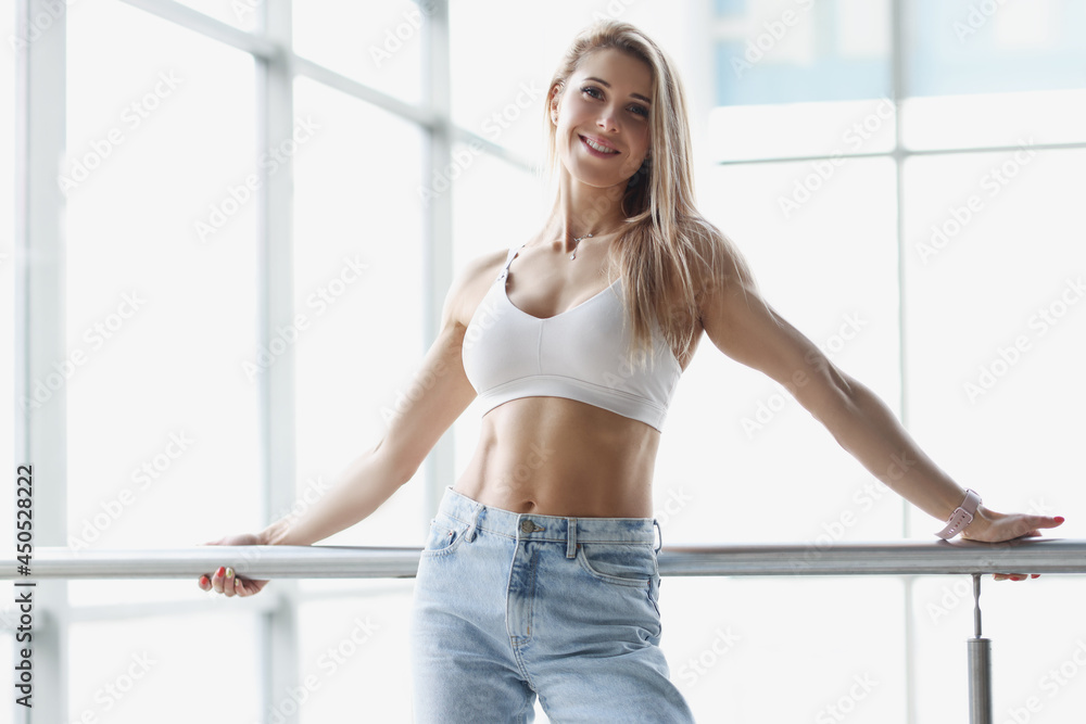 Portrait of young blonde woman in sports top and jeans Portrait of young blonde woman in sports top and jeans