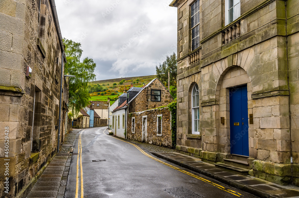 A view up a side street leading out of Falkland, Scotland on a summers day
