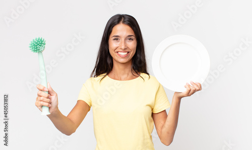 pretty hispanic woman holding an epty clean dish photo