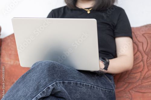 Wallpaper Mural Woman sitting on wood chair and using laptop computer. Torontodigital.ca