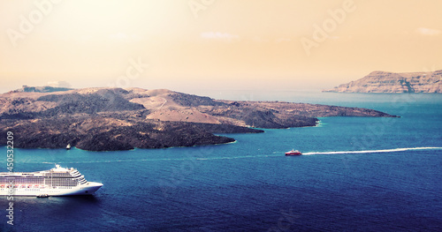 Aerial view of modern luxury tourist cruise ship in the bay of Santorini, Greece