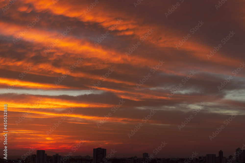 Sunrise skyline with red color fire on a cloudy winter day on a city. Space for text. Sunrise skyline with red color fire on a cloudy winter day on a city. Space for text.