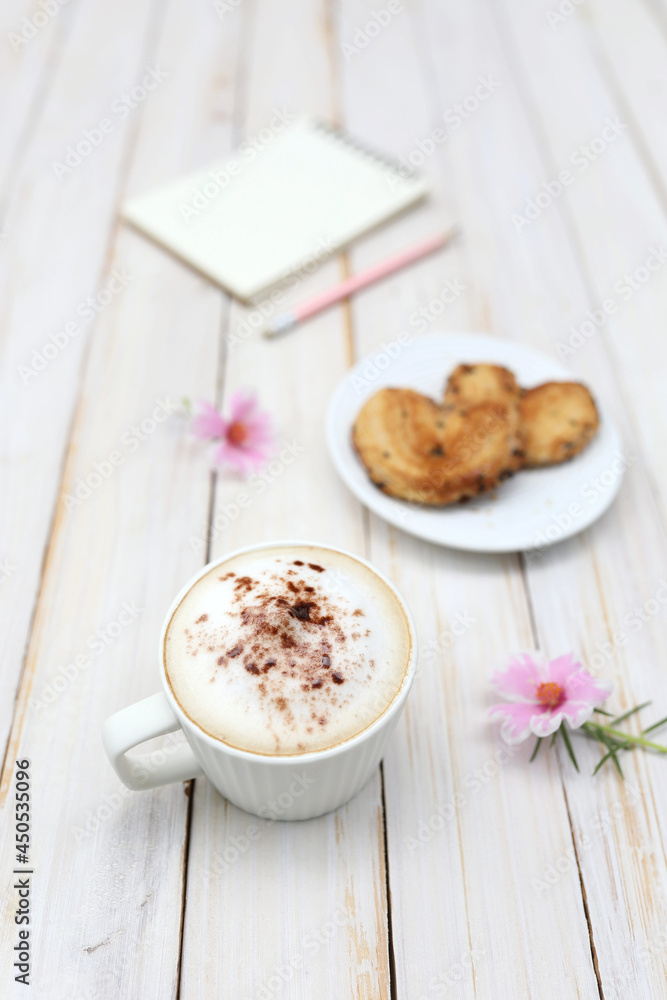 cappuccino coffee and pie with Purslane flower and notebook on wooden table cappuccino coffee and pie with Purslane flower and notebook on wooden table