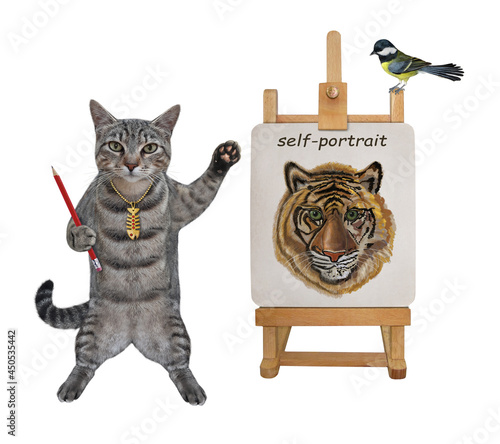 A gray cat artist with a pencil paints his self-portrait on a canvas on an easel. White background. Isolated.