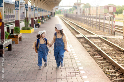 Two girls on a railway station, waiting for the train