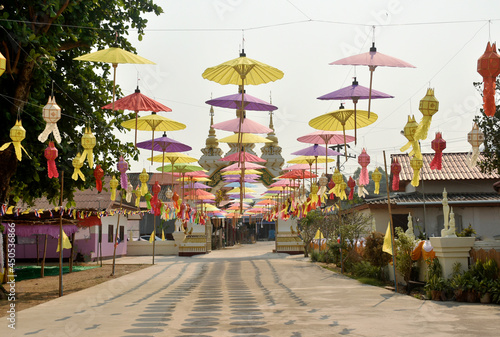 Colorful paper umbrellas were hung to decorate the corridor from the temple gate against the sky background.