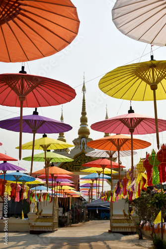 Colorful paper umbrellas were hung to decorate the corridor from the temple gate against the sky background.