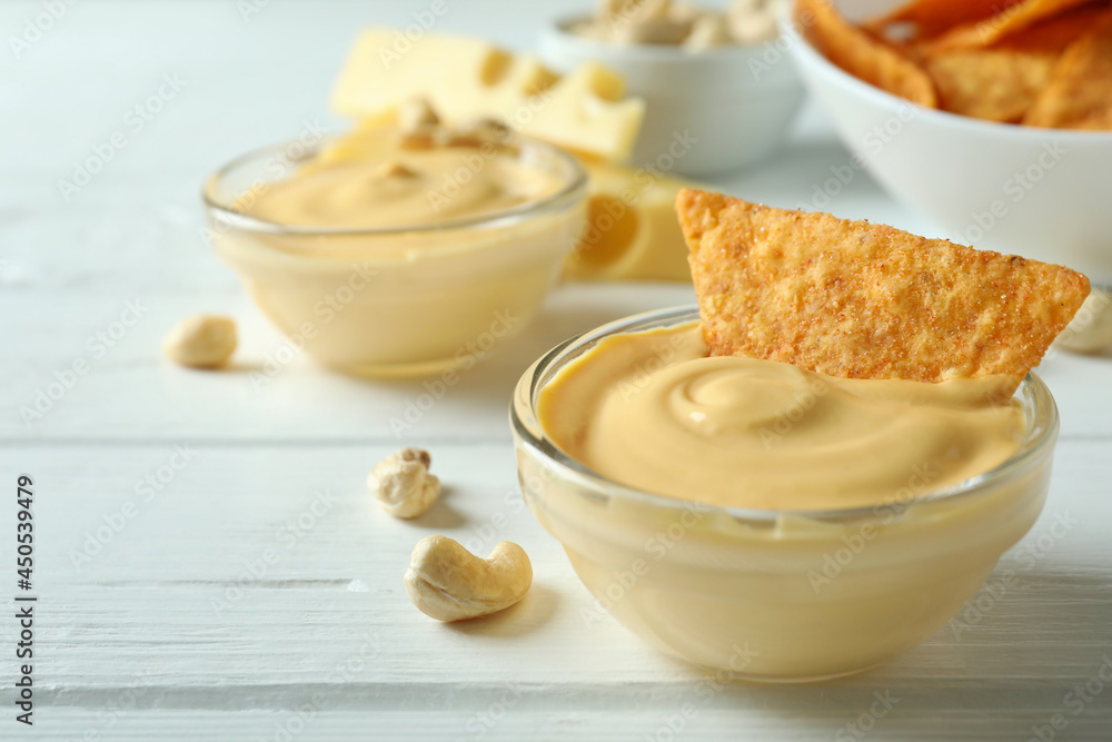Snacks with cheese sauce on white wooden table Snacks with cheese sauce on white wooden table