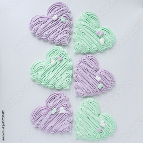 Large beautiful meringue hearts in two colors decorated  with small hearts photo