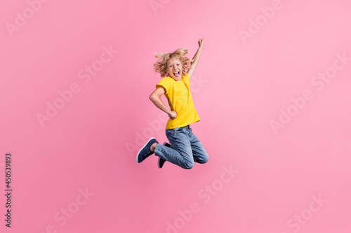 Full size profile side photo of young boy happy positive smile jump fly air superman isolated over pink color background