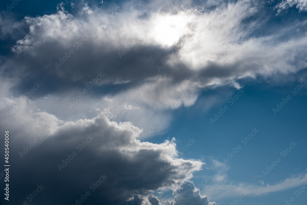 Fototapeta premium Amazing panoramic view against the backdrop of white clouds and blue sky. Beautiful clouds with sunbeams shining through.