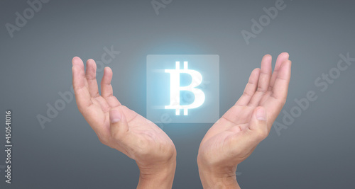 Hands showing bitcoin icon as virtual money digital