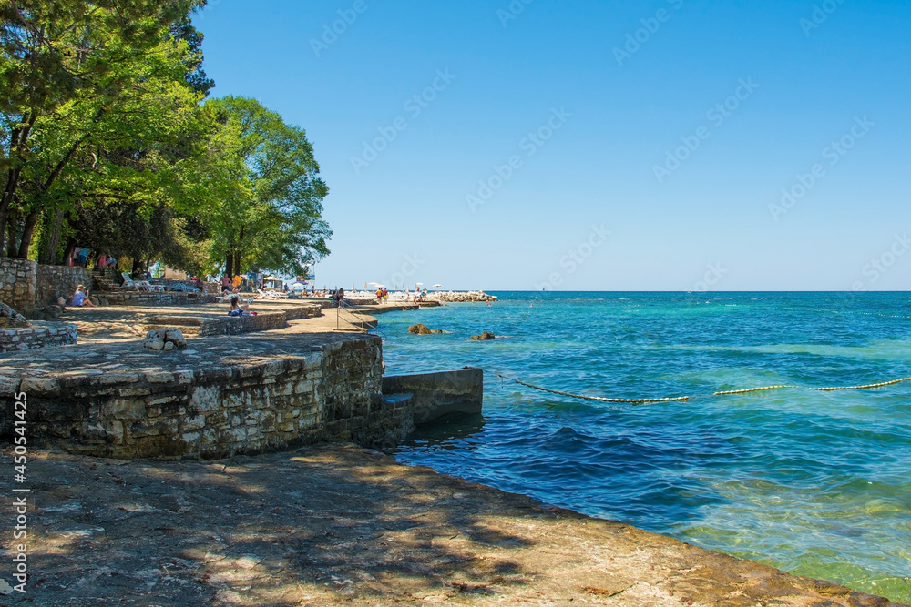 Tourists and locals enjoy the summer sun and sea on the coast just north of the historic centre of Porec on the Istria coast of Croatia
Tourists and locals enjoy the summer sun and sea on the coast just north of the historic centre of Porec on the Istria coast of Croatia
