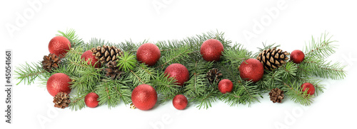 Spruce branches with Christmas baubles isolated on white background