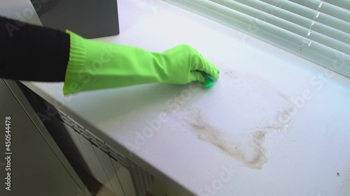 Wallpaper Mural A hand wipes the dirt from the windowsill with a rag Torontodigital.ca