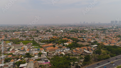Fototapeta Naklejka Na Ścianę i Meble -  Aerial cityscape modern city Surabaya with highway, skyscrapers, buildings and houses. city skyline with skyscrapers and business centers Surabaya capital city east java, indonesia