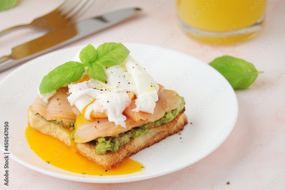 Breakfast with a sandwich with poached egg and avocado Breakfast with a sandwich with poached egg and avocado