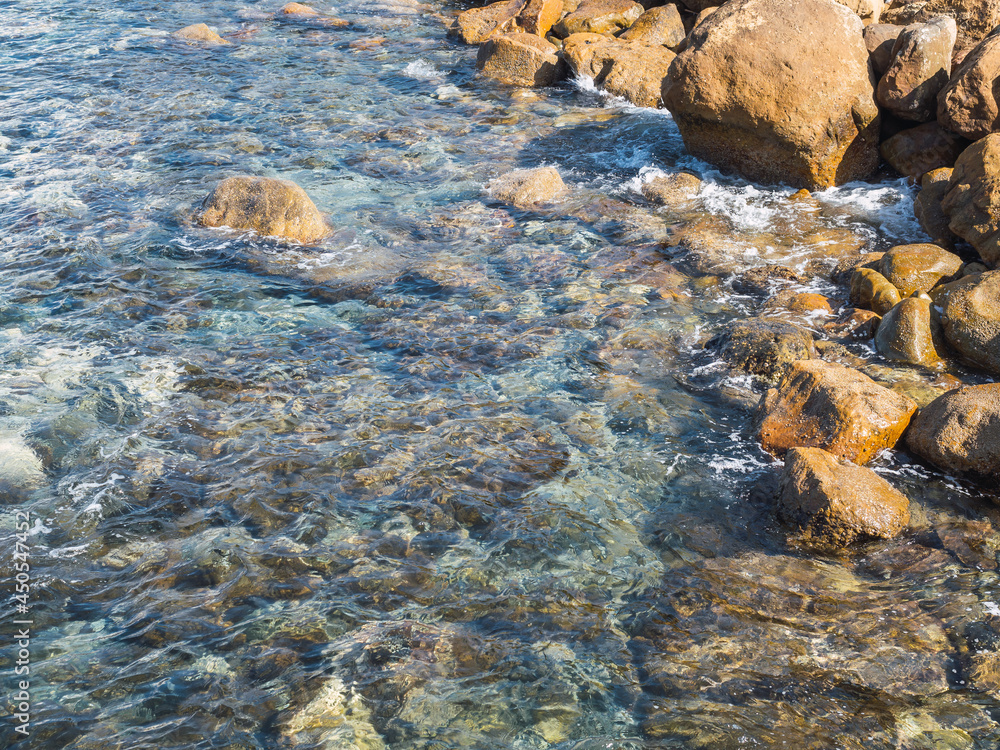 Shore with rocks and turquoise water of mediterranean sea in Estepona, Costa del Sol, Spain