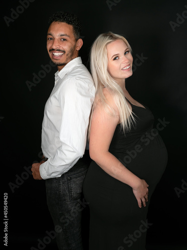 Stylish and happy multi-ethnic couple expecting a baby