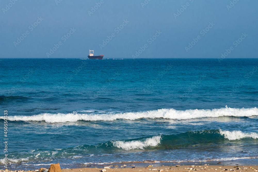 three waves near the shore. a blurred ship on the horizon. Sea waves, water tide. seascape. Raging sea waves. Selective focus. High quality photo