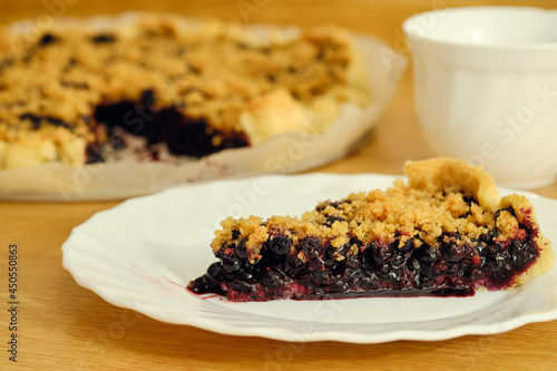 Blueberry pie on plate and cup