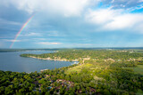 Wide aerial shot of a rainbow over a lake