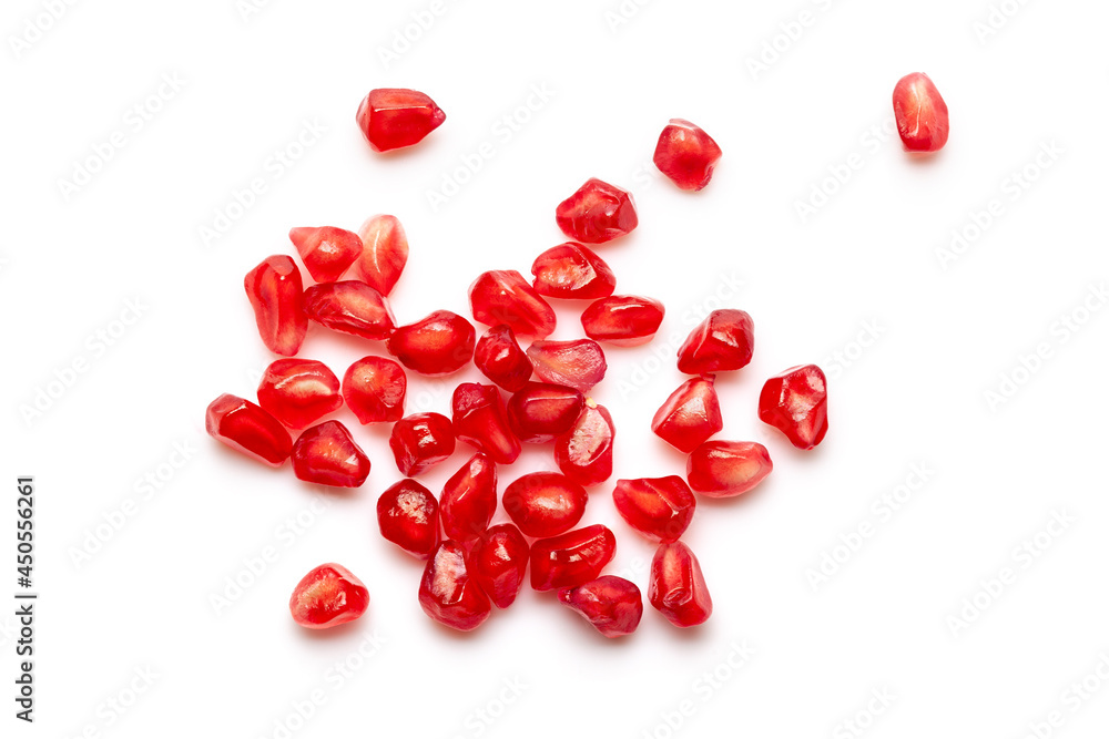 Micro Close-up of organic red pomegranate seed (Punica granatum) isolated over white background.
