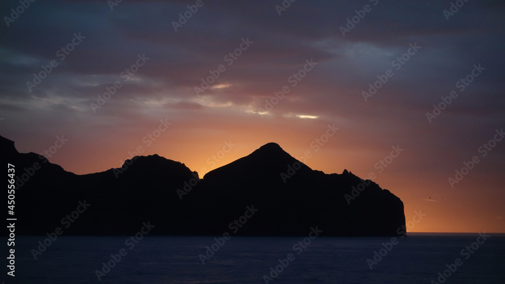 sunset over the sea and volcanic mountain silhouette, Heimaey, Vestmannaeyjar islands, Iceland sunset over the sea and volcanic mountain silhouette, Heimaey, Vestmannaeyjar islands, Iceland