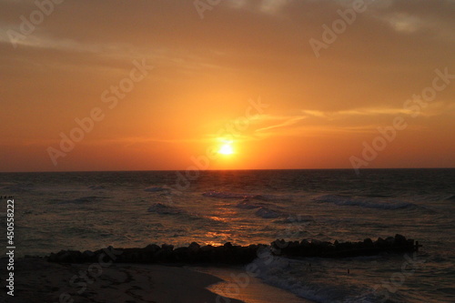 Atardecer en la playa puesta de sol en el mar con cielo naranja