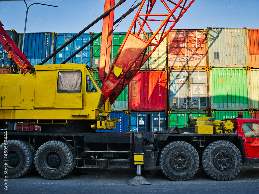 big mobile crane parking near the container zone location at the harbour