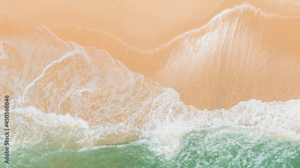 Obraz premium Top view or aerial view of Beautiful crystal clear water and white beach.Fantastic colorful sunset on surfing coastline.Waves rolling from above breaking beach.