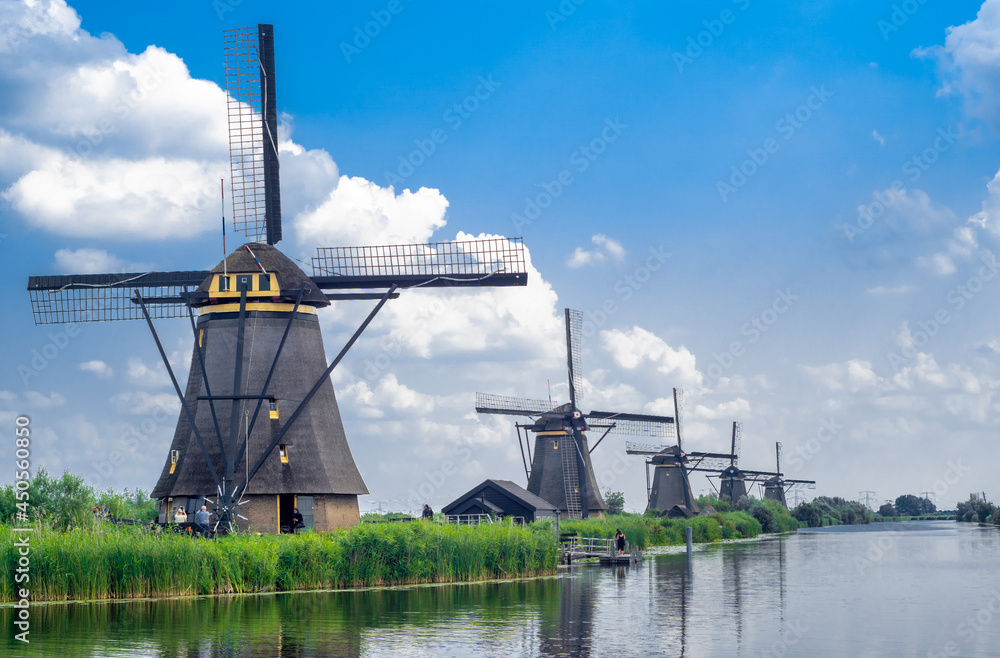 Traditional landscape of the Netherlands. Many dutch windmills by water canal at Kinderdijk village.