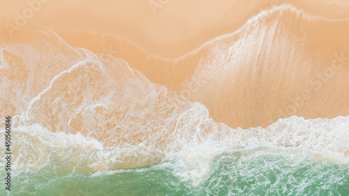 Top view or aerial view of Beautiful crystal clear water and white beach.Fantastic colorful sunset on surfing coastline.Waves rolling from above breaking beach.