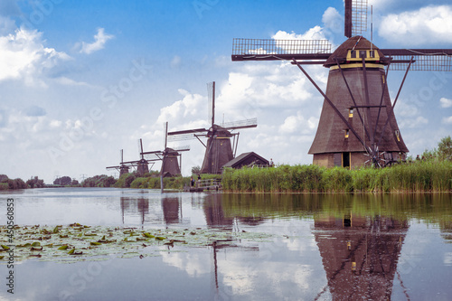 Typical Dutch landscape in vintage colors with windmills and water canal. Kinderdijk village in cloudy sky, rainy weather in the Netherlands.
