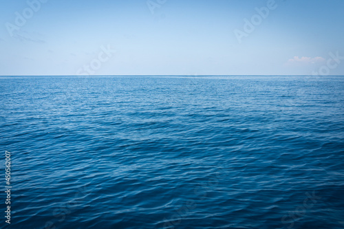 blue sea background.Marine sea surface reflecting the sun with coral reef under the water