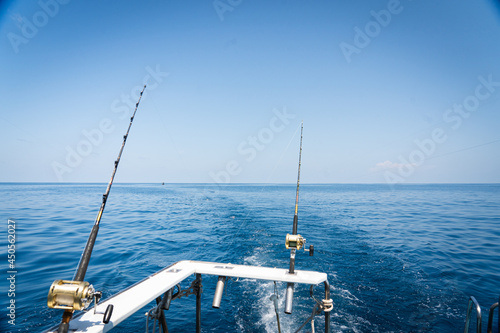 Fishing trolling tuna with speedboat on the pacific ocean. Blue sky and blue water.fishing trawler sways on the waves of the Pacific Ocean.